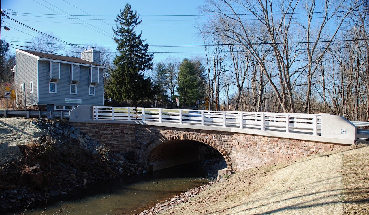 View of Frontline Arts from bridge across brook, on Lenapehoking