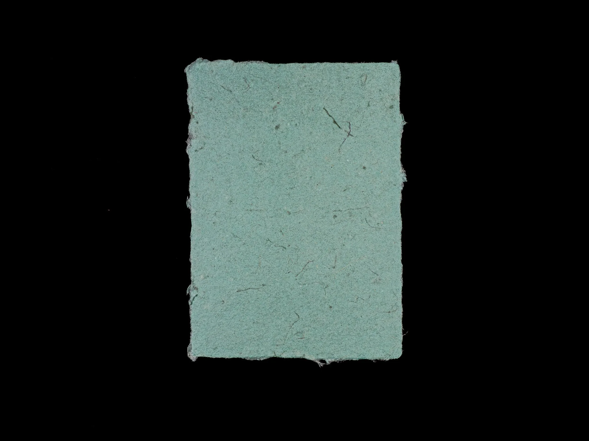 5 inch by 7 inch handmade paper made from multiservice pulp with added gray-green pigment.