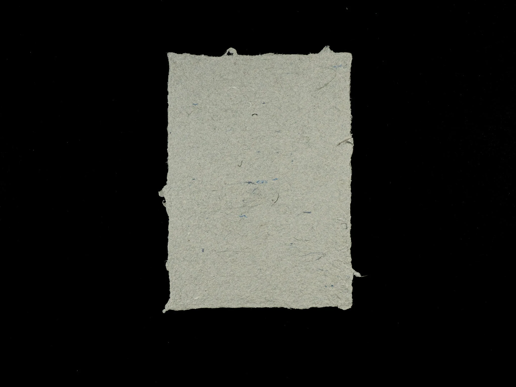5 inch by 7 inch handmade paper made from light gray multiservice pulp and 4 percent World War 2 wool.