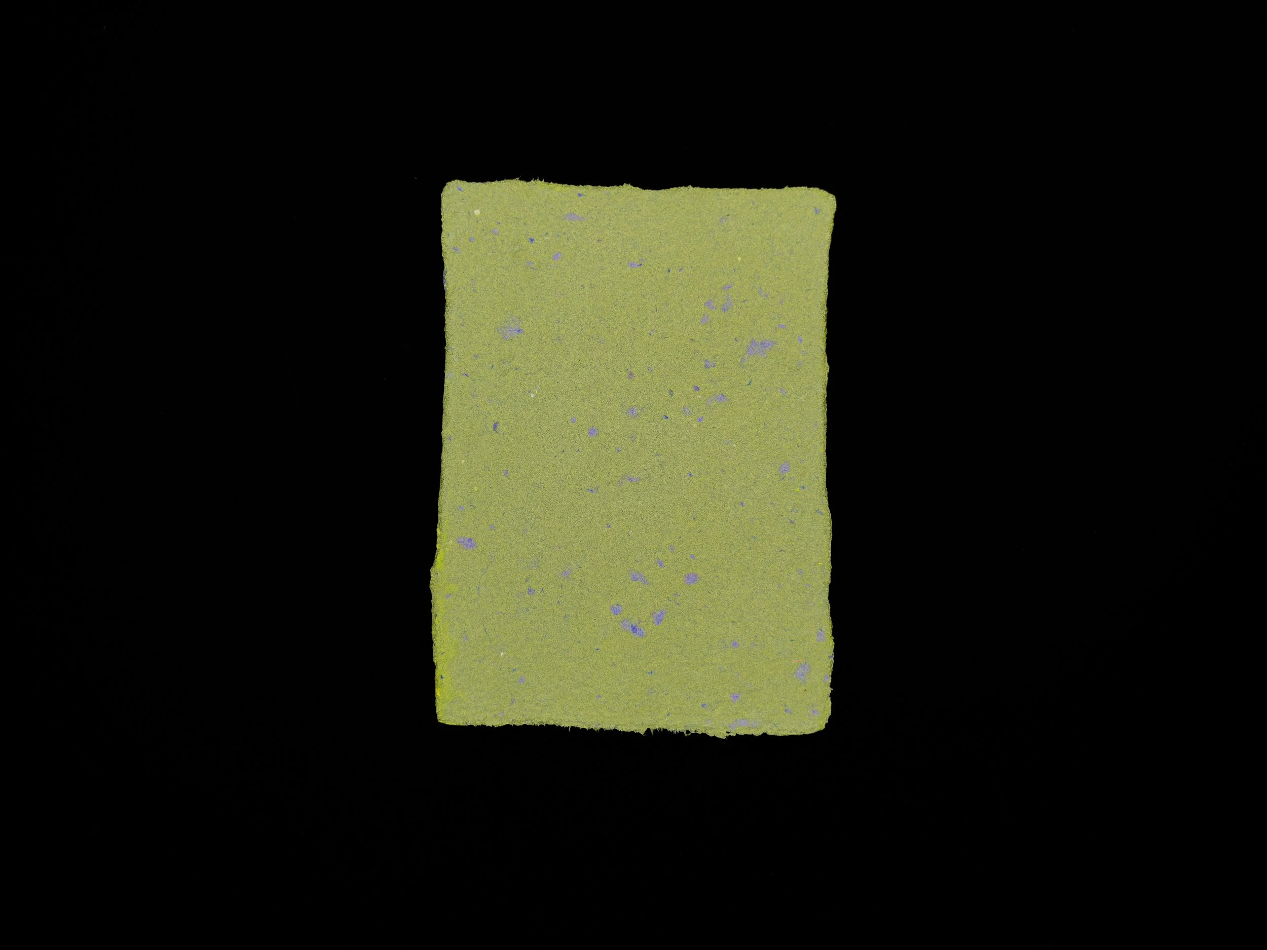 Olive green sheet of handmade paper on a black background.