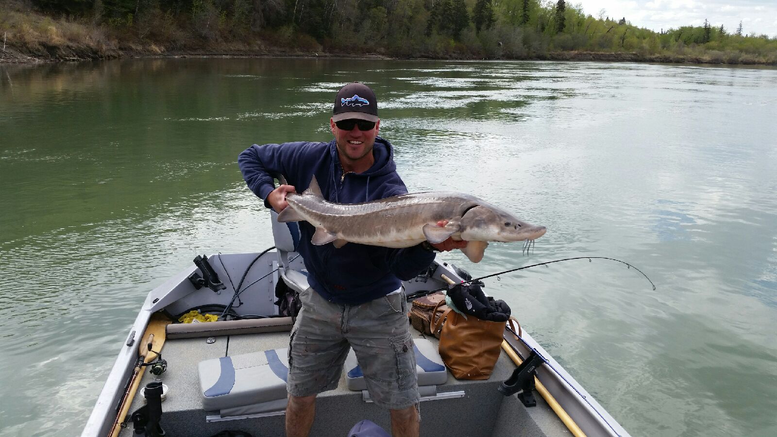 Nick and a tank of a sturgeon! This guy was not very long but had some weight to him. Edmonton, Alberta, Canada.