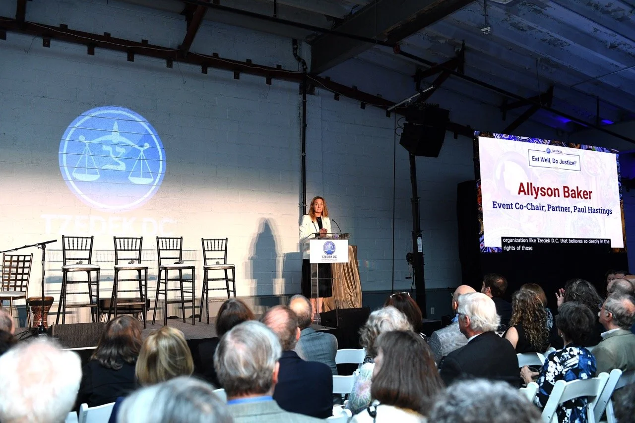 Allyson Baker at podium with name on screen Large.jpeg