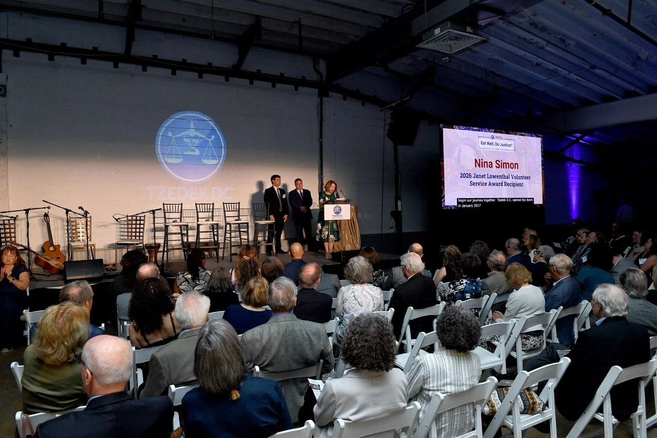 Nina at podium, name on screen Large.jpeg