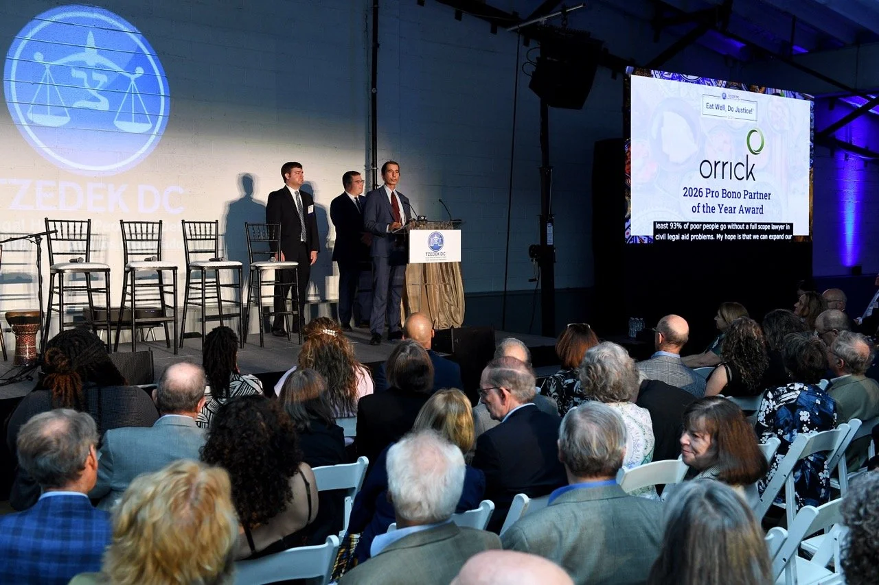 Rene (Orrick) at podium, Orrick on screen 2 Large.jpeg