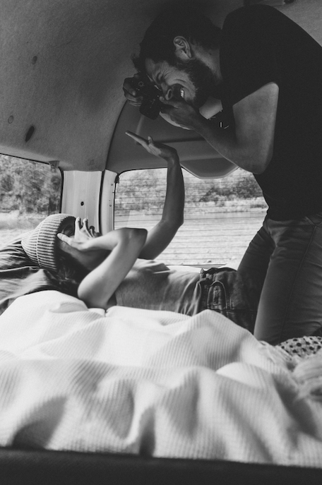 Luke taking a photo of Tara in the back of a campervan