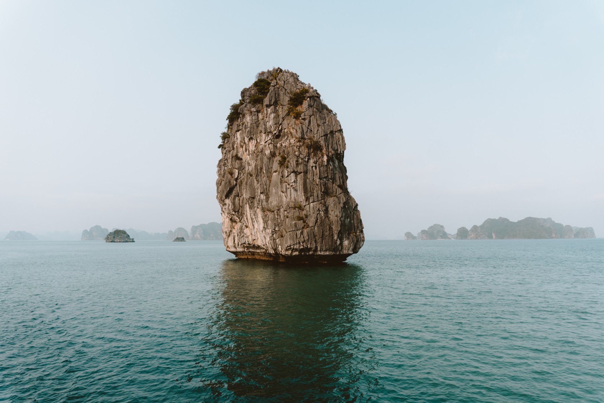View of a single rock in the ocean, Ha Long bay, Vietnam