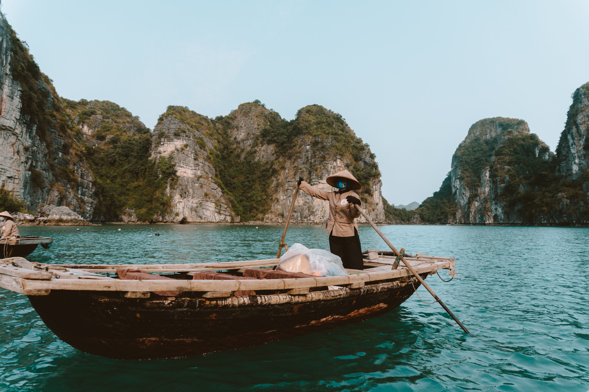 A local woman rowing a boat in Ha Long bay, Vietnam