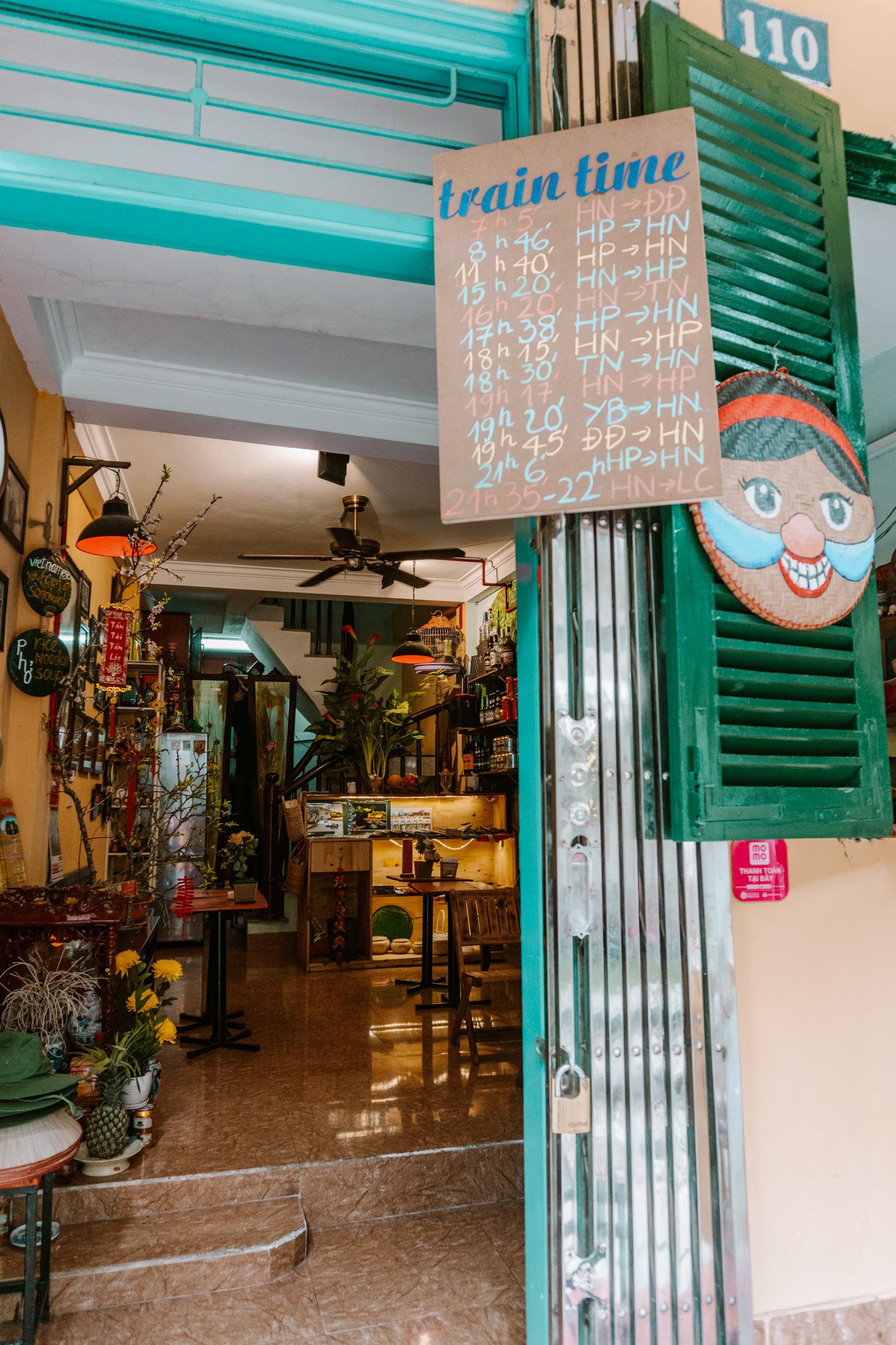 a poster showing train times at a cafe along Train Street, Hanoi, Vietnam