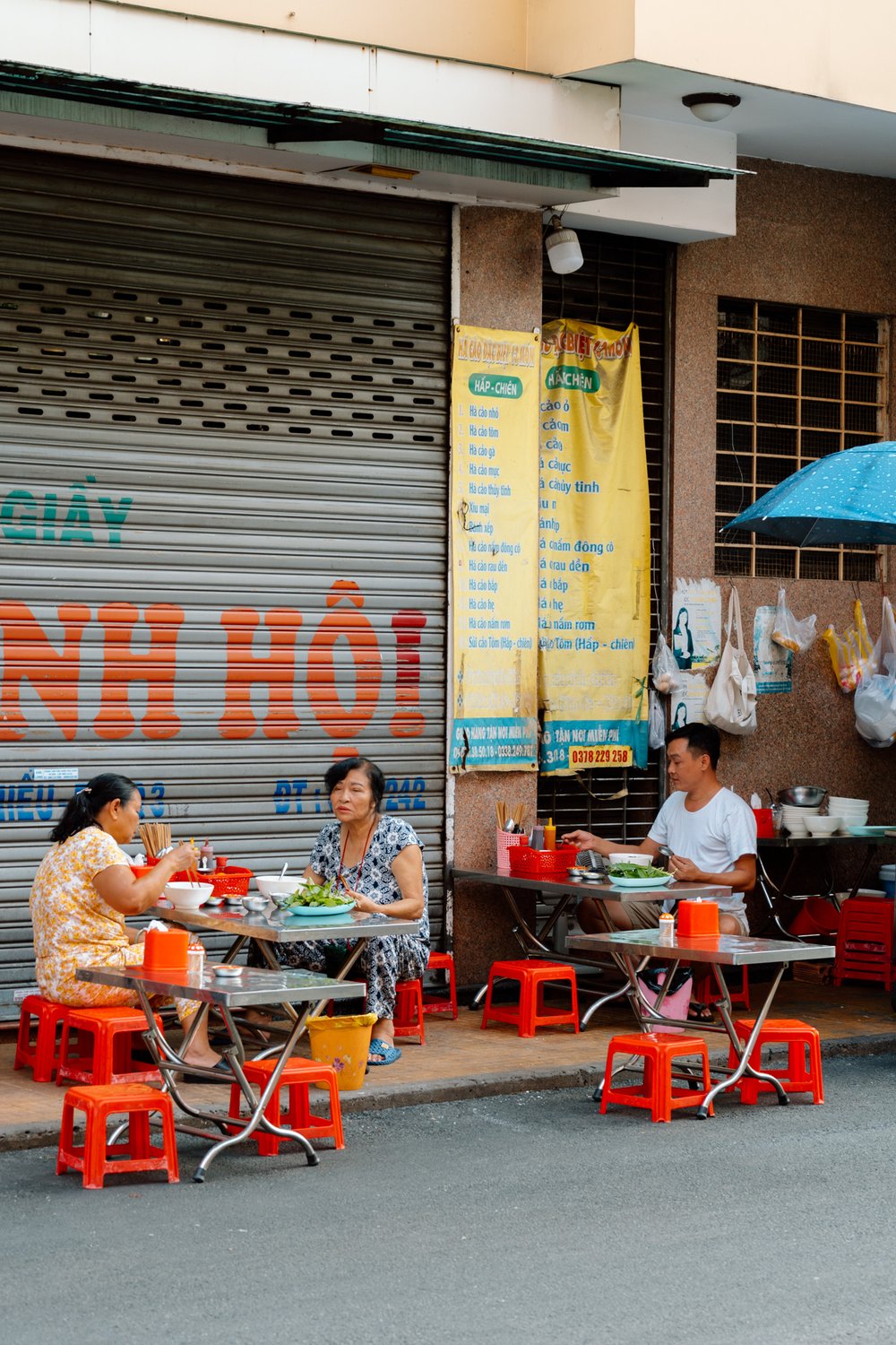 people eating street food in Saigon