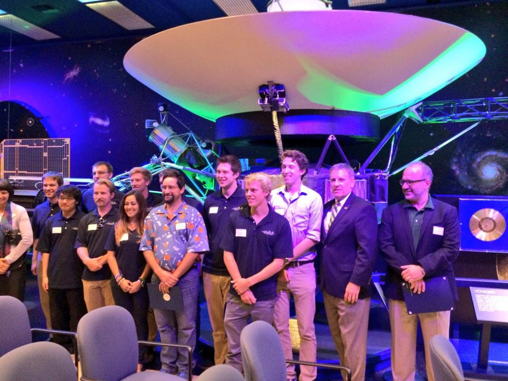 Cal Poly’s President Jeffrey Armstrong and the Dean of Engineering Debra Larson with the PolySat and CubeSat team in front of Voyager at JPL.