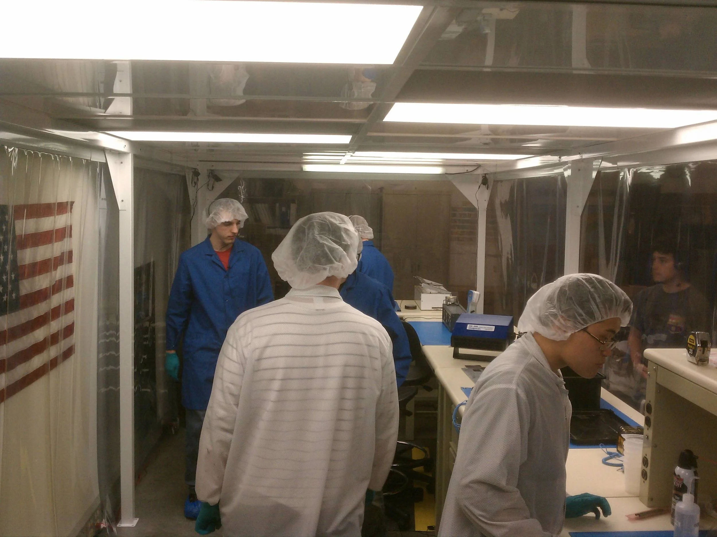 PolySat students busy in the clean room, learning how to install solar cells