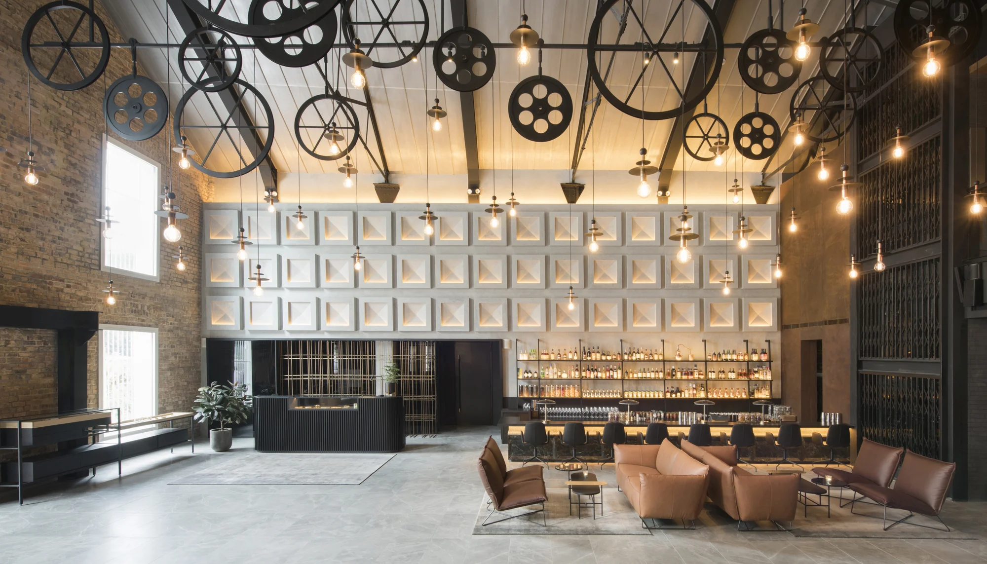 Intricate and vintage machinery wheels act as decorative accents in the hotel lobby.