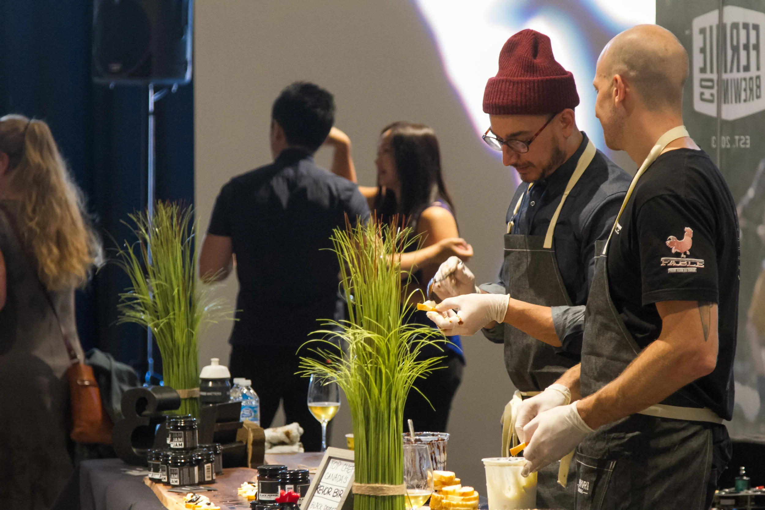 Trevor Bird preparing the black jam crostini himself at the Cheese and Meat Festival Vancouver.