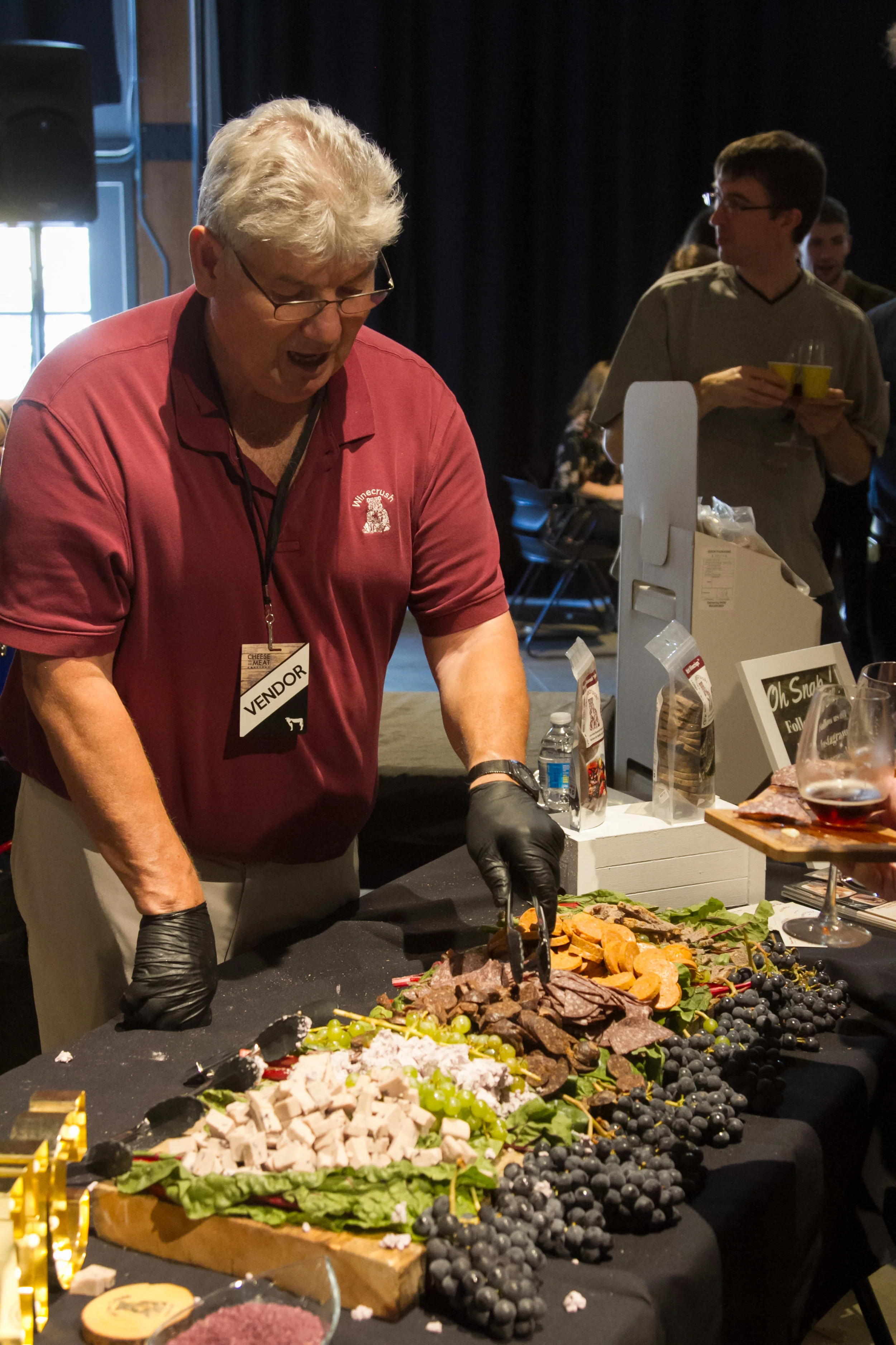Bill Broddy of WineCrush serving samples to attendees at the Cheese and Meat Festival
