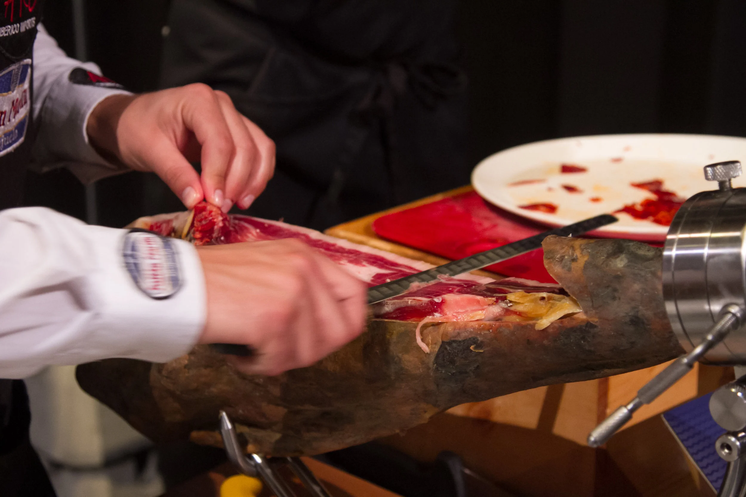 Hand carving Iberico prosciutto.