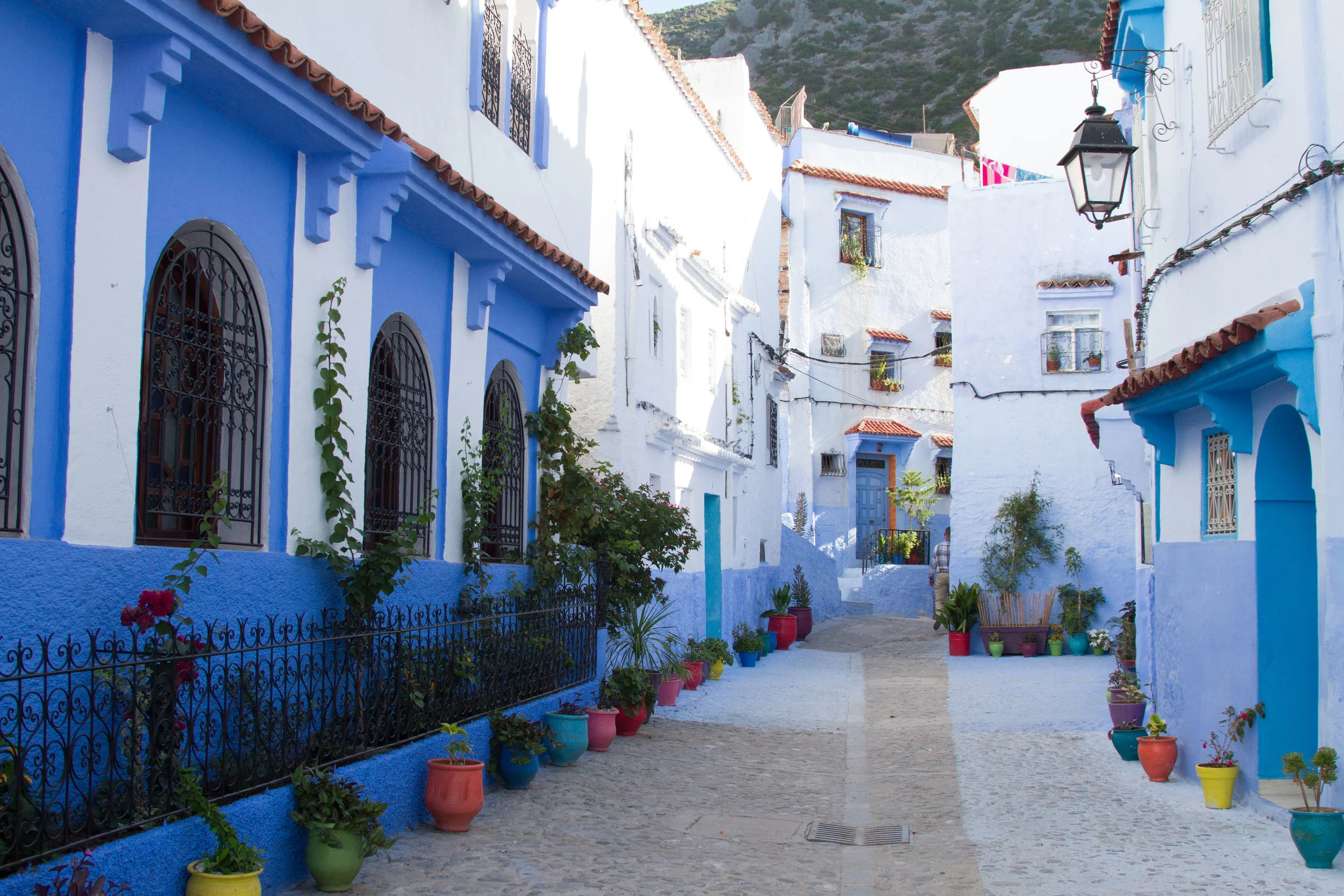 Colourful pots line the street in Chefchaouen