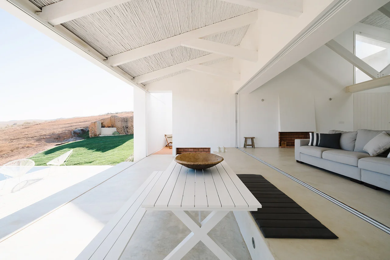 The home with the sliding panels open to reveal the horizon.