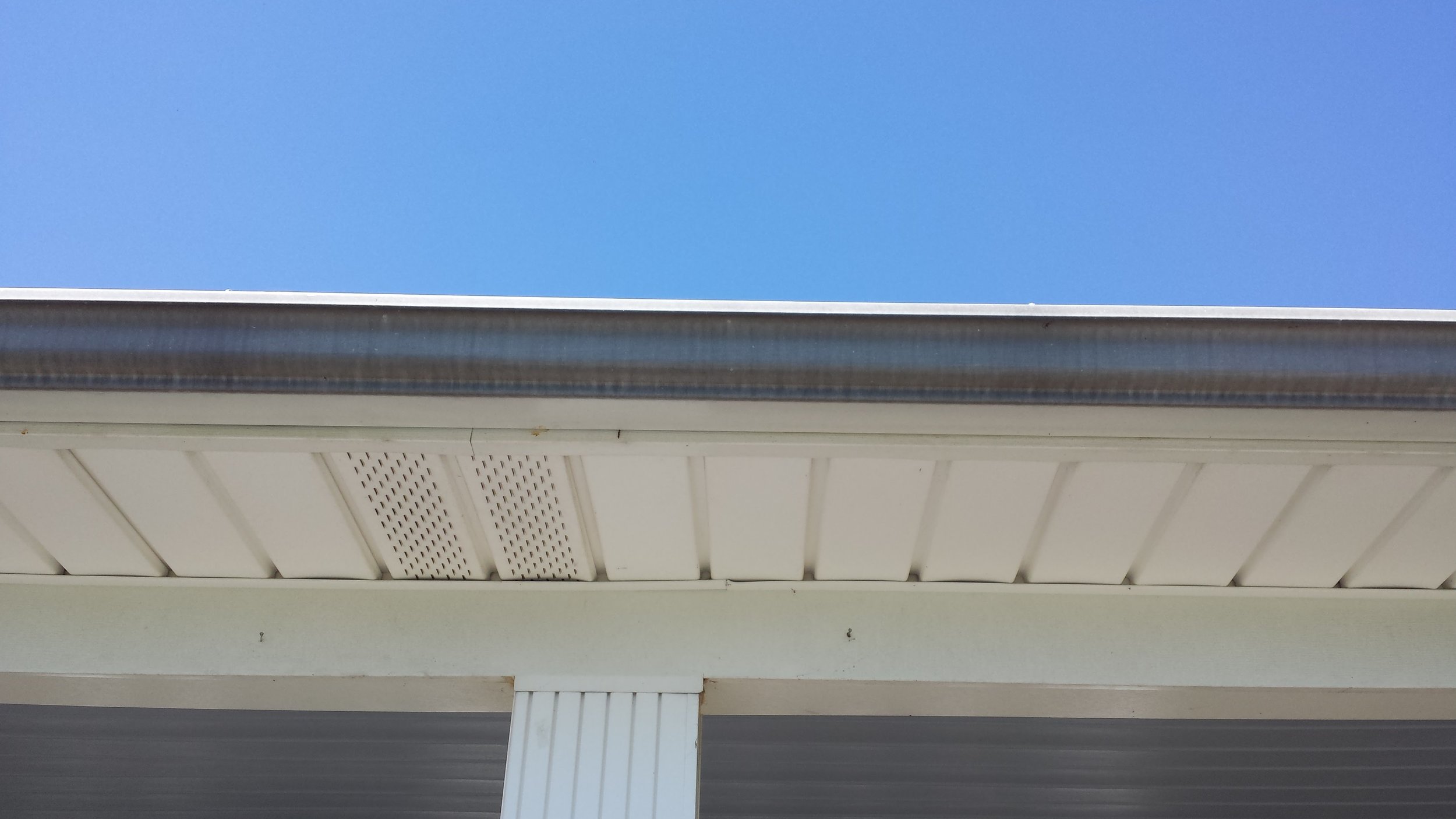 Dark "Tiger Stripes" - Before. Gutter Cleaning in Lexington North Carolina.