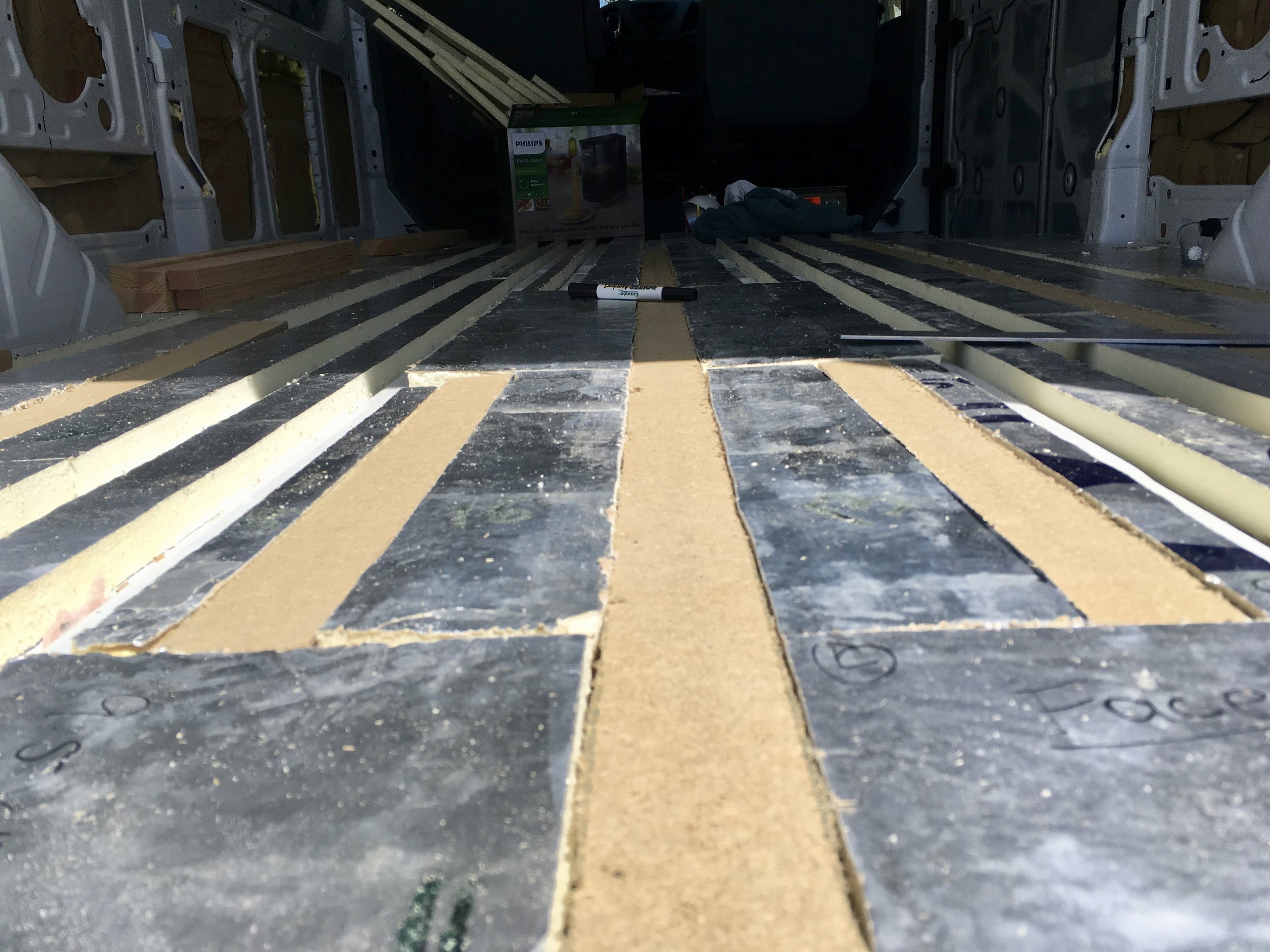 Van floor, complete with bumps, ridges, and cracks.