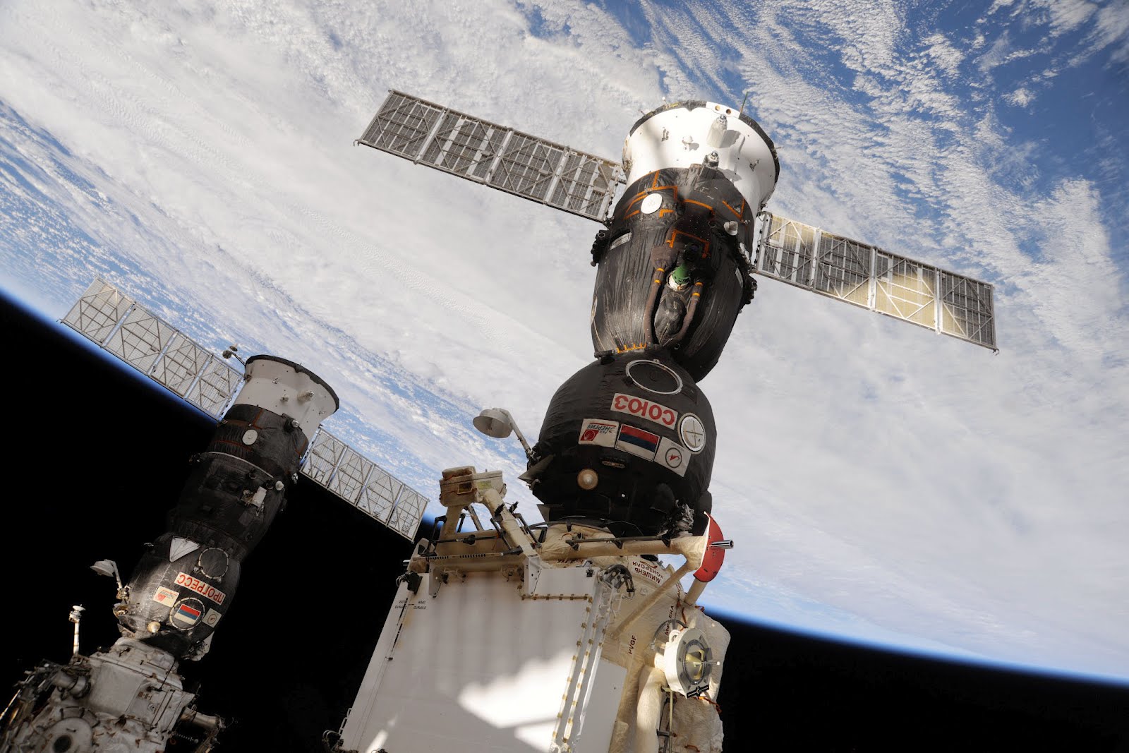  Earth rotates beneath a Soyuz docked to the  Rassvet  module of the International Space Station. Photo Credit: NASA 