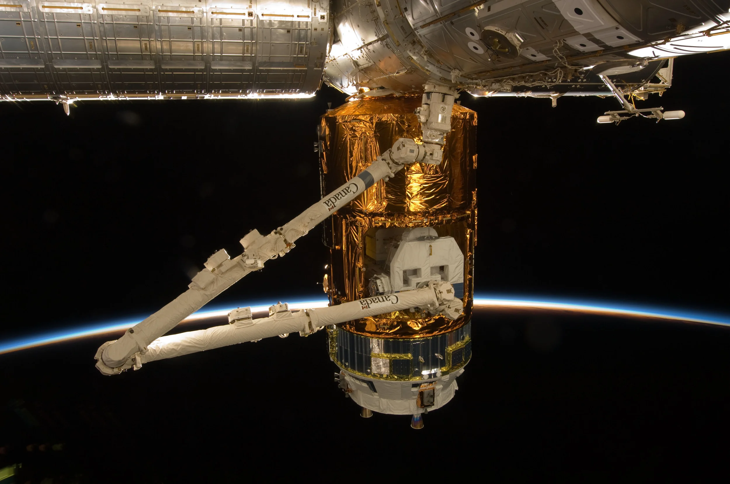 Canadarm2 extracts cargo from Kounotori's Unpressurized Logistics Carrier. Photo Credit: NASA