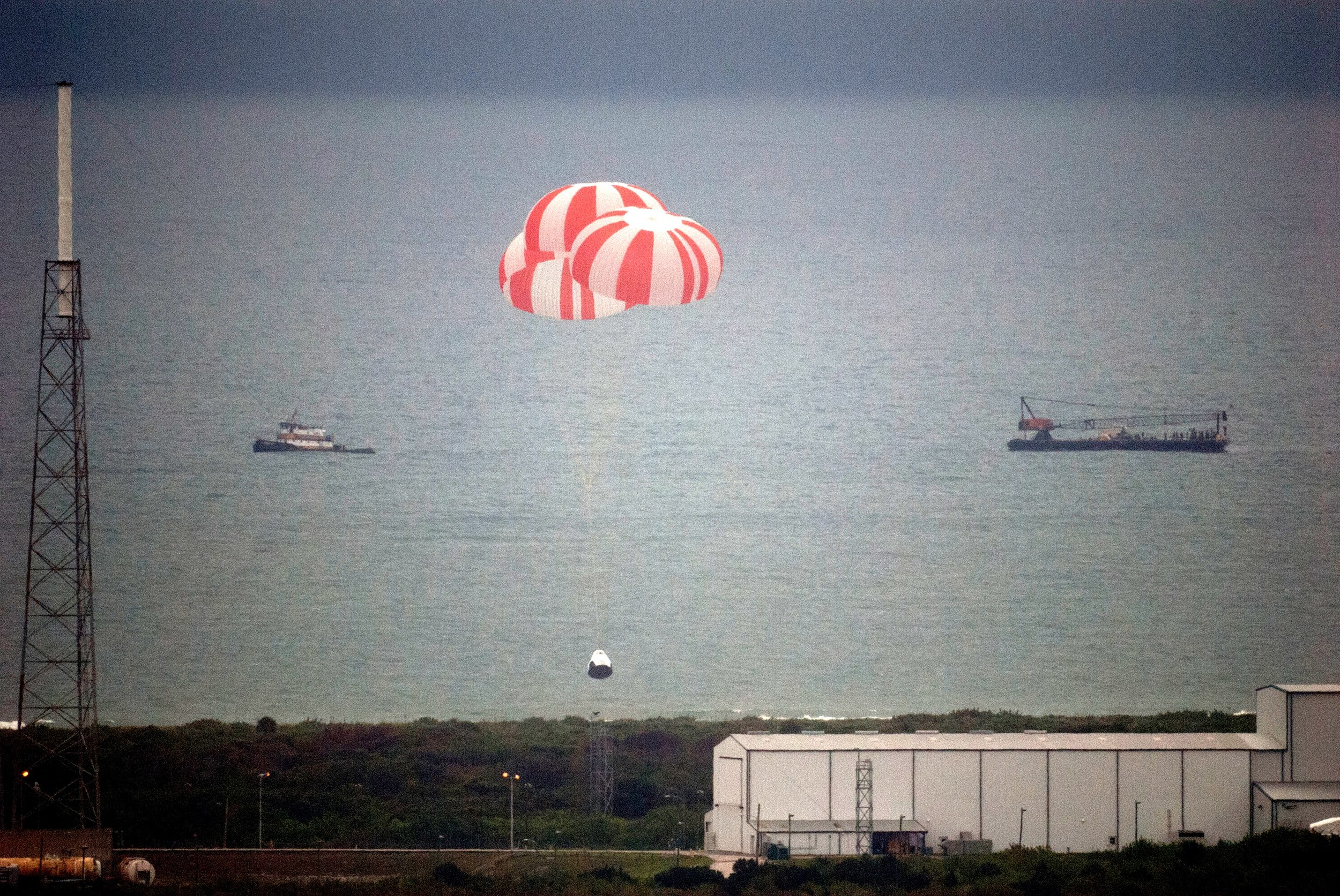  The Crew Dragon capsule parachutes into the ocean after the Pad Abort test. Photo Credit: SpaceX 