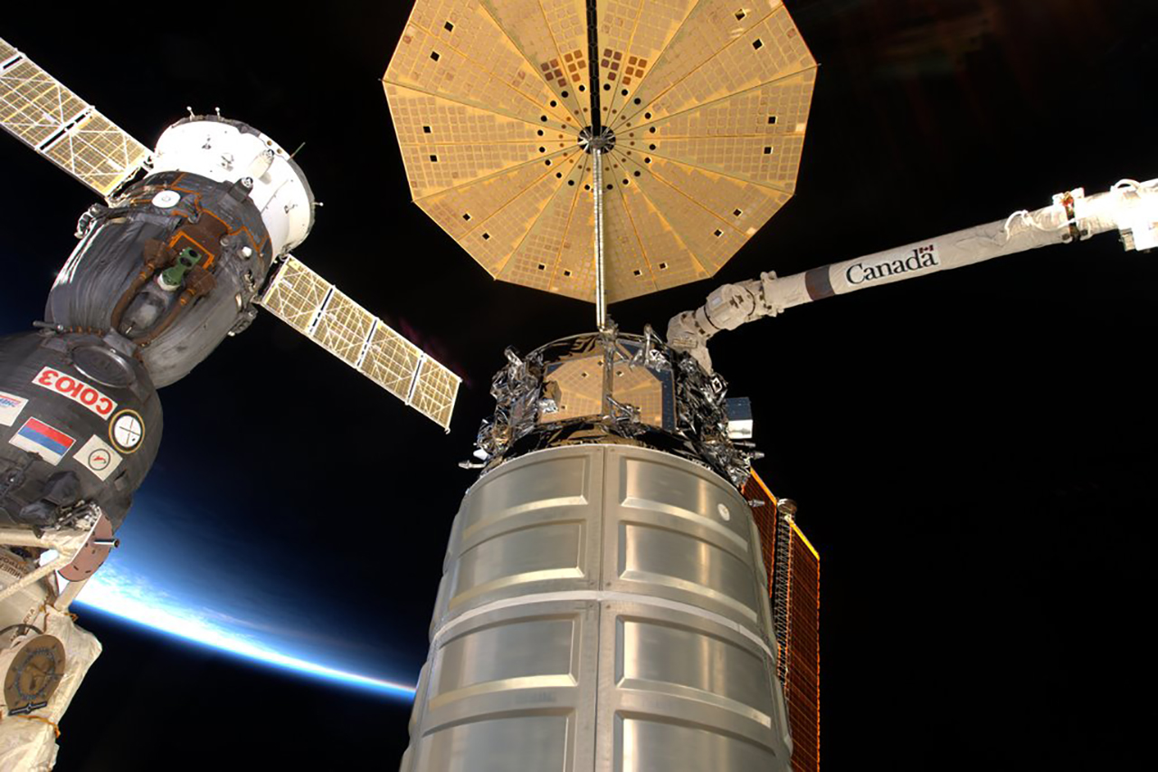 A Cygnus attached to the outpost with a Soyuz in the background. Photo Credit: NASA 