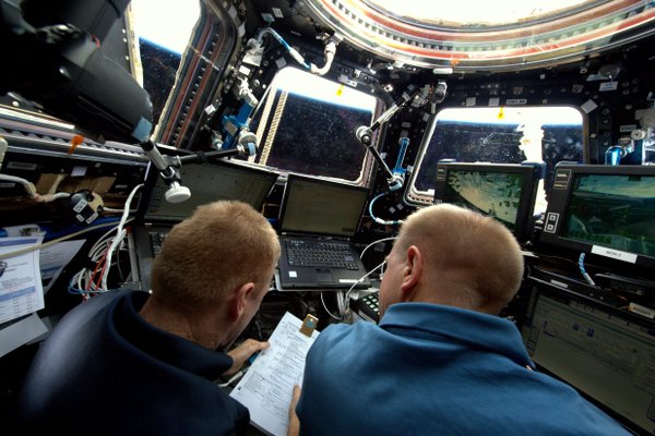  Astronauts control the robotic arm from the bay window-like Cupola. Photo Credit: NASA 