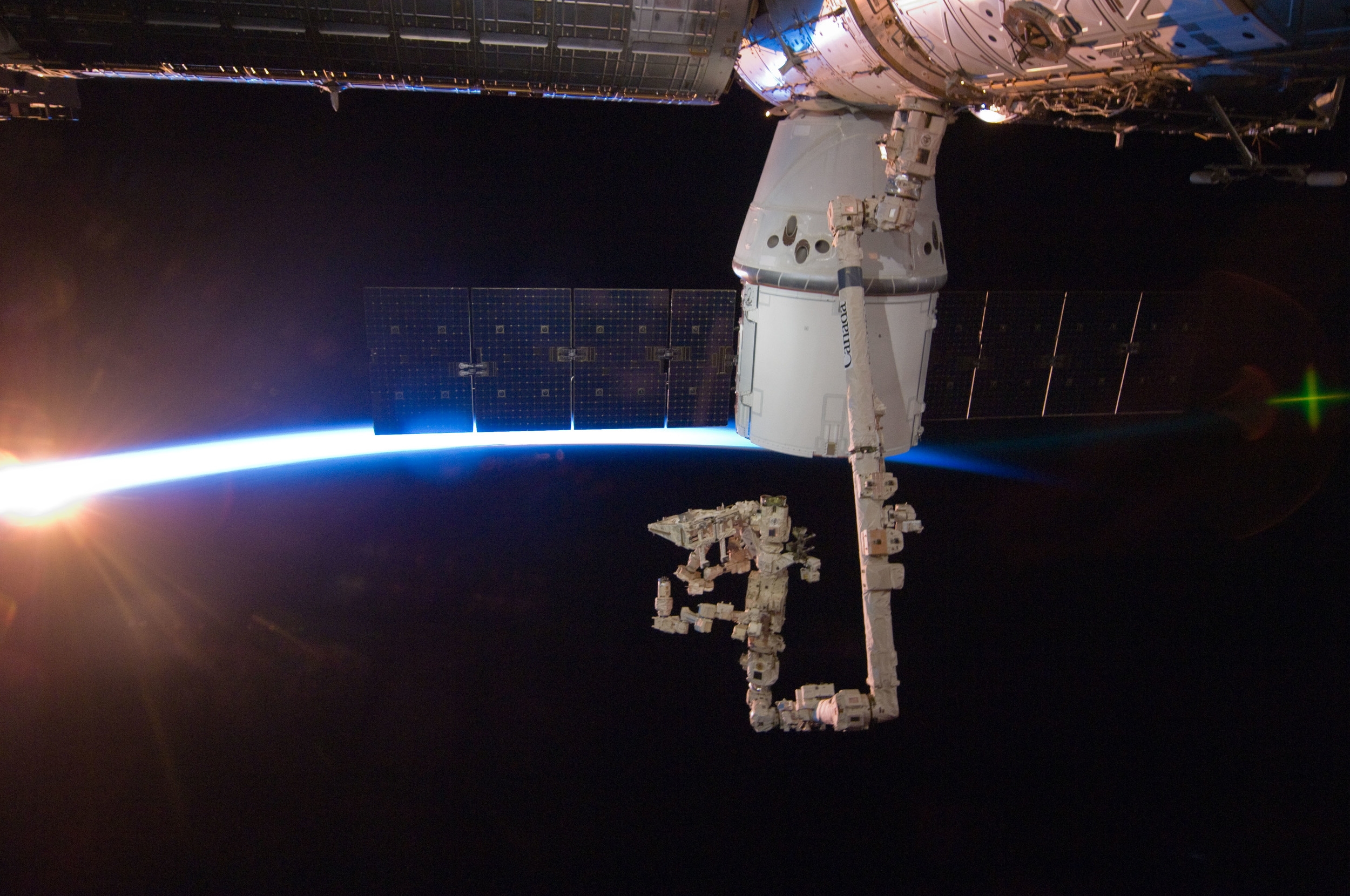  The space station passes into an orbital sunrise with Dragon berthed to the  Harmony  module. Photo Credit: NASA 
