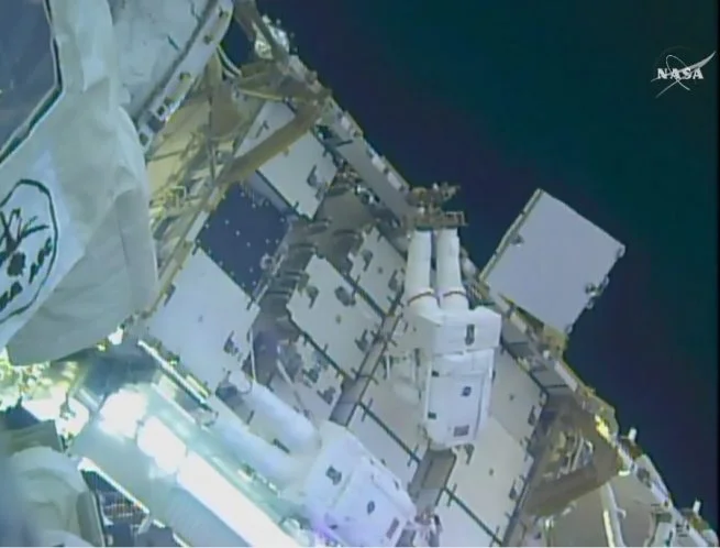 Kimbrough, top, and Whitson work to attach the adapter plates on the 3A power channel. Photo Credit: NASA TV