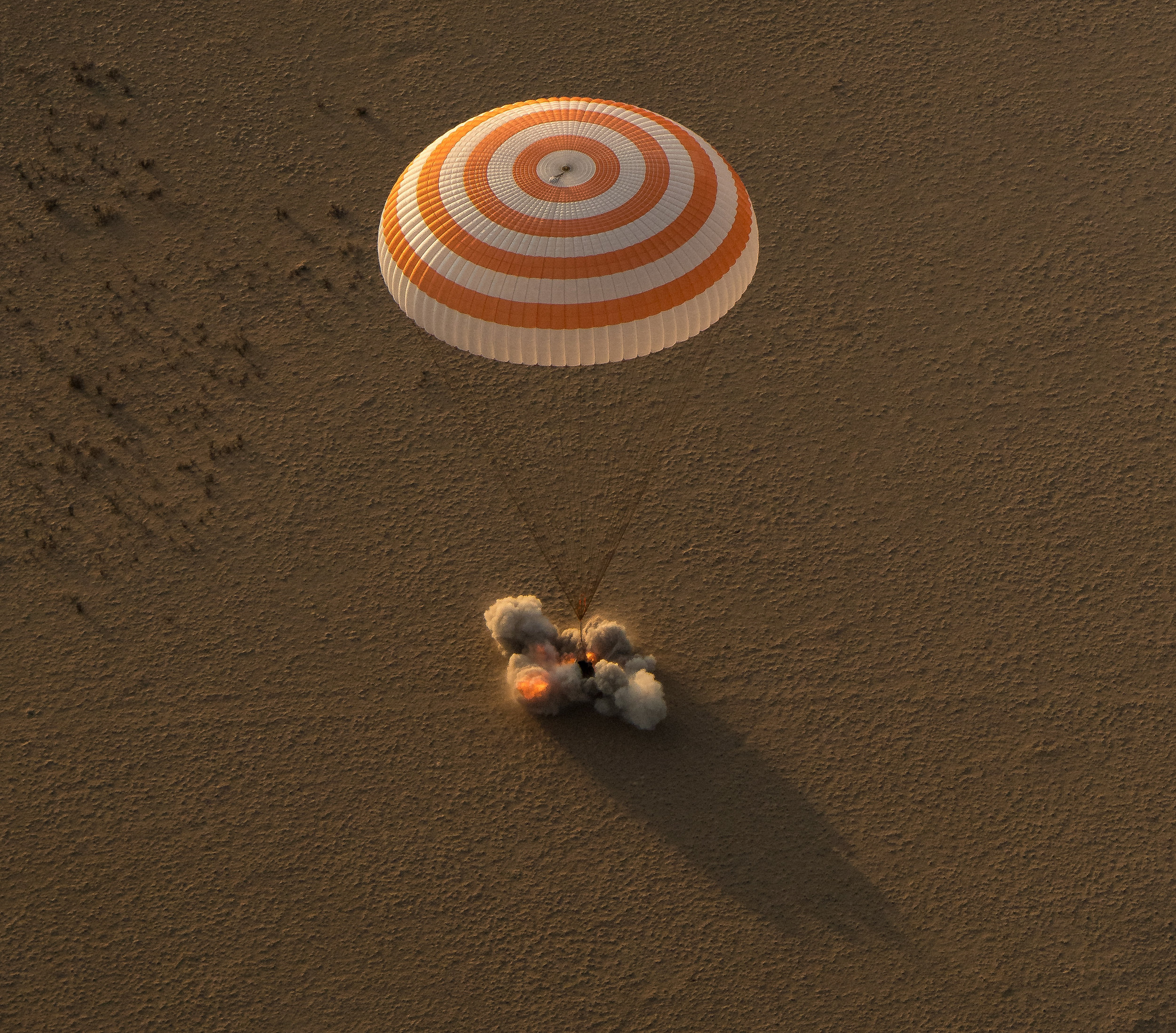  The Soyuz's Soft Landing engines fire to cushion the capsule's impact with the ground. Photo Credit: Bill Ingalls / NASA 