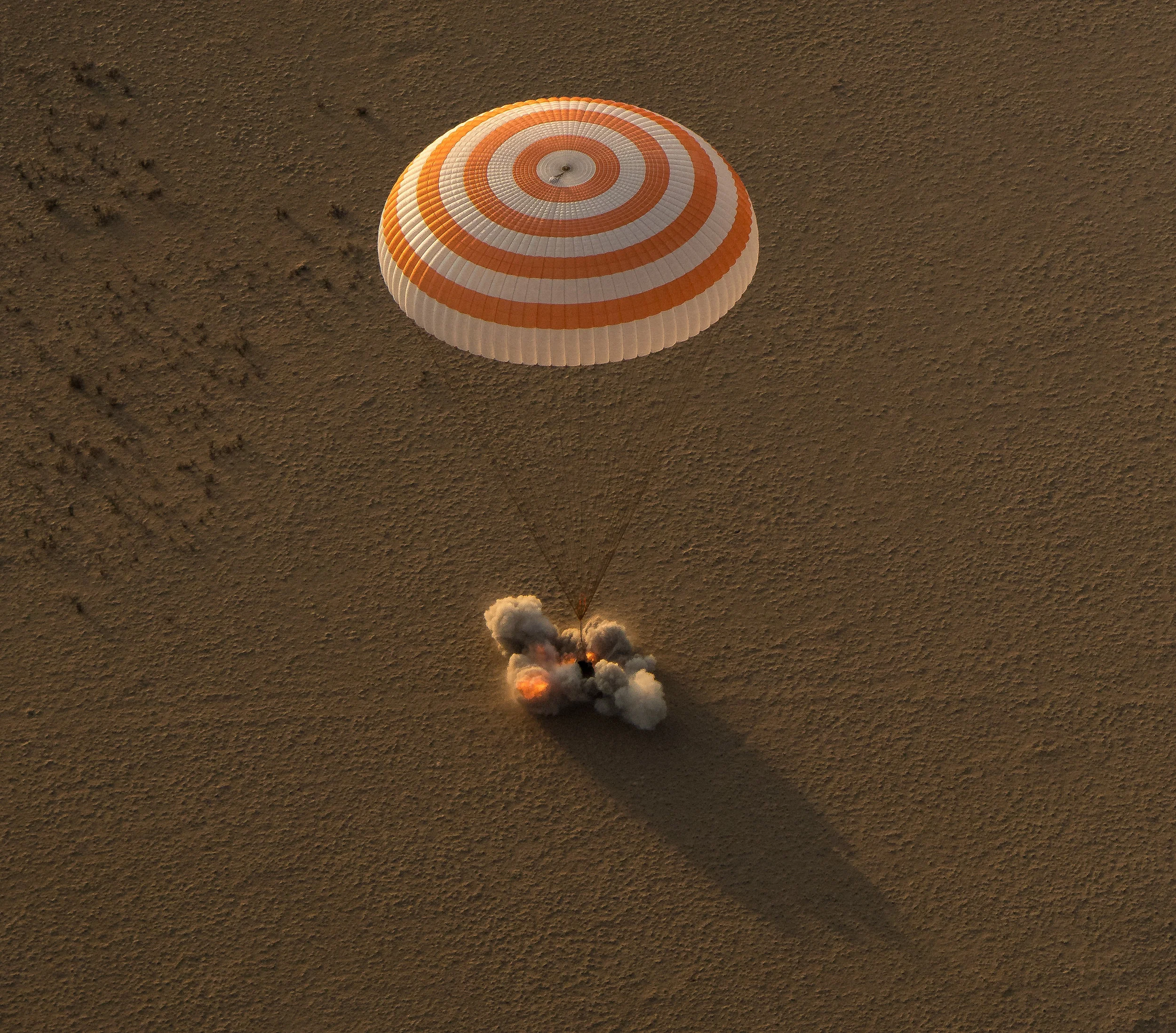 The Soyuz's Soft Landing engines fire to cushion the capsule's impact with the ground. Photo Credit: Bill Ingalls / NASA