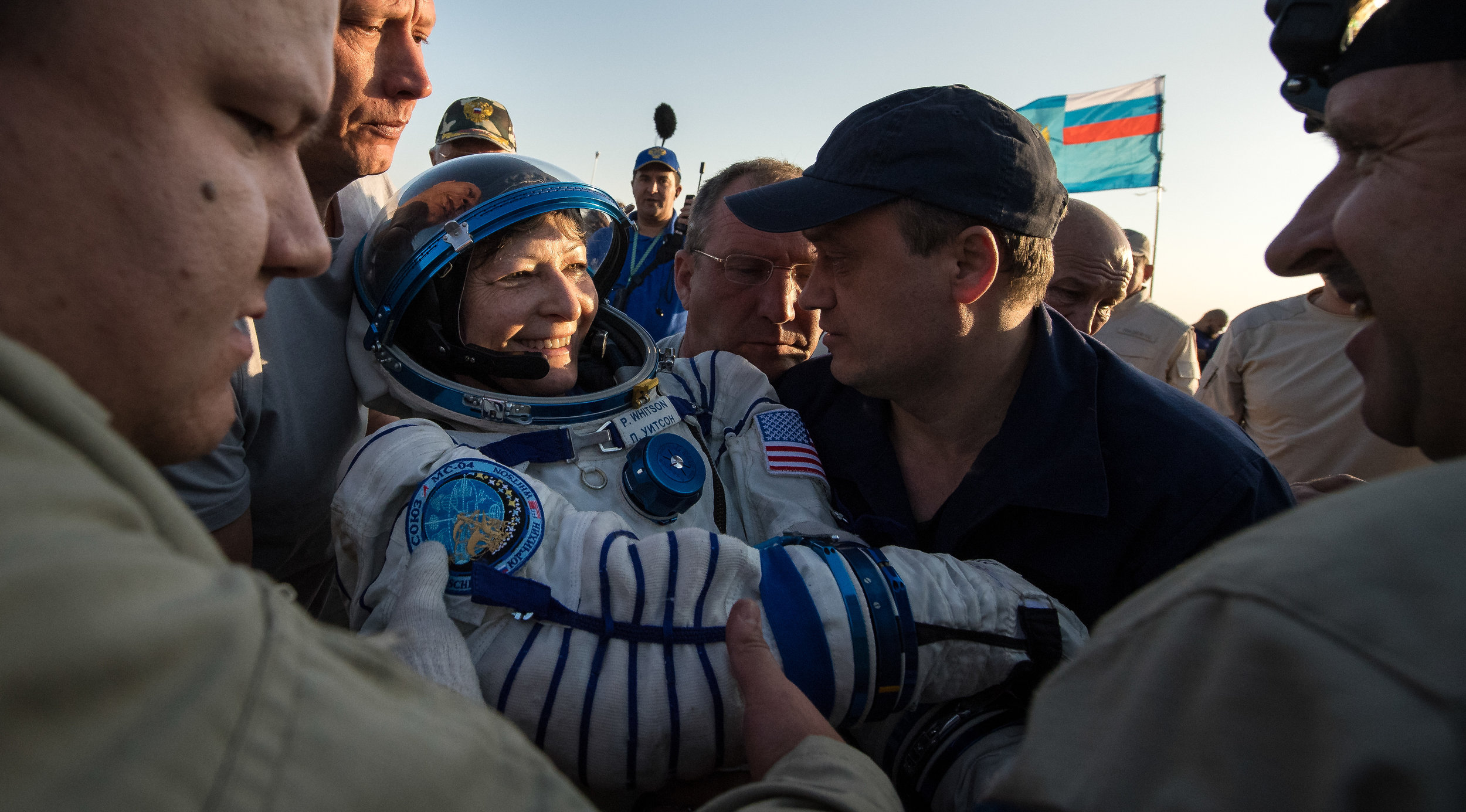  Peggy Whitson was the final crew member of Soyuz MS-04 to be helped out. All three were placed on lawn chair-like couches for an initial health check before being transported to a nearby medical tent for further evaluation. Photo Credit: Bill Ingall