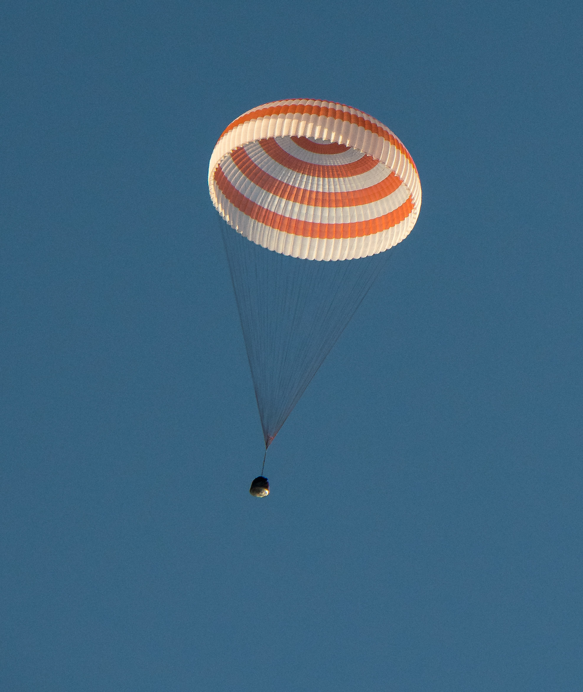  The Soyuz MS-04 capsule descends under its single main parachute. Photo Credit: Bill Ingalls / NASA 