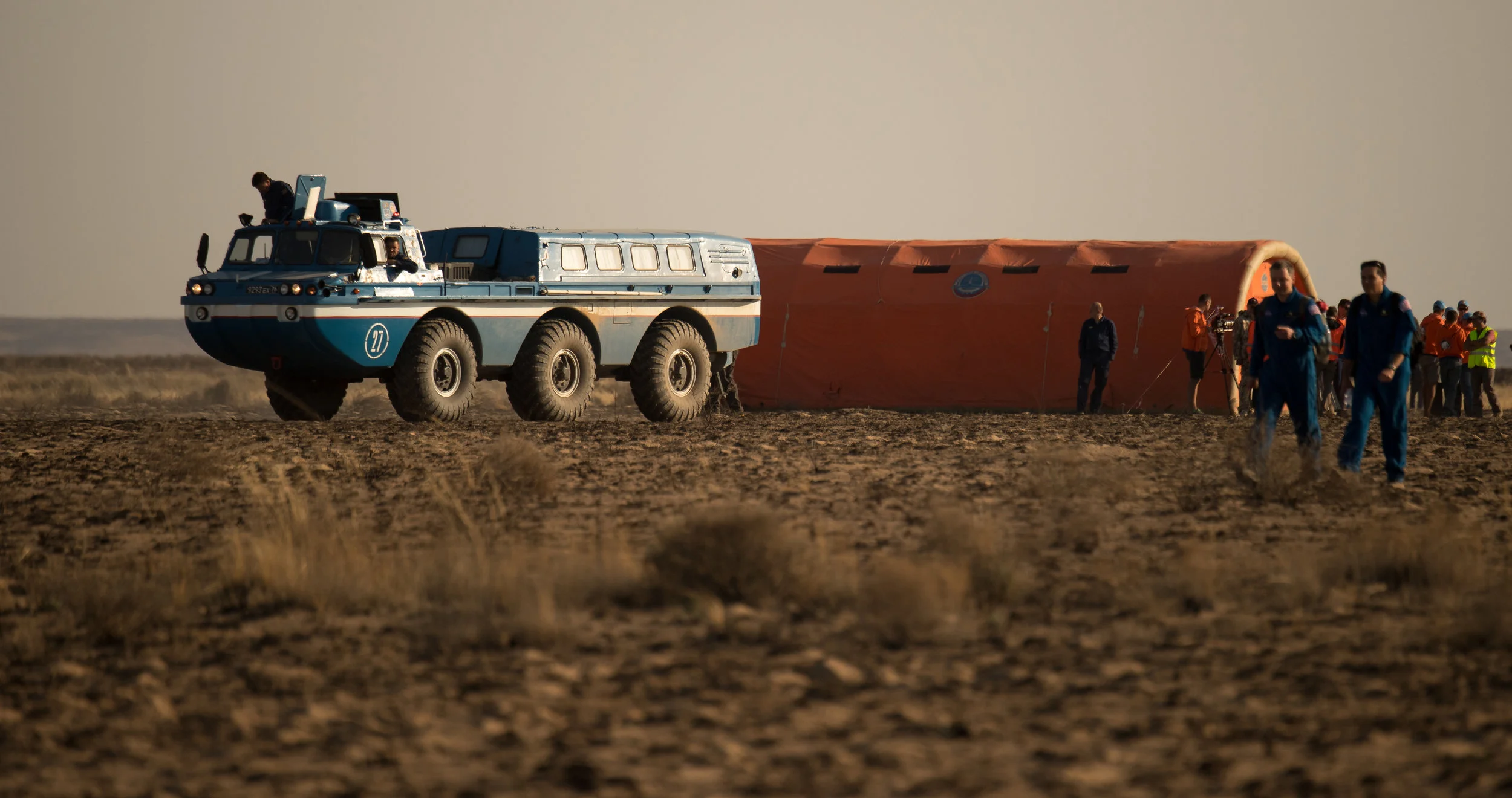 The crew is moved into an inflatable medical tent for evaluations before being transported to their respective space agency headquarters. Photo Credit: Bill Ingalls / NASA
