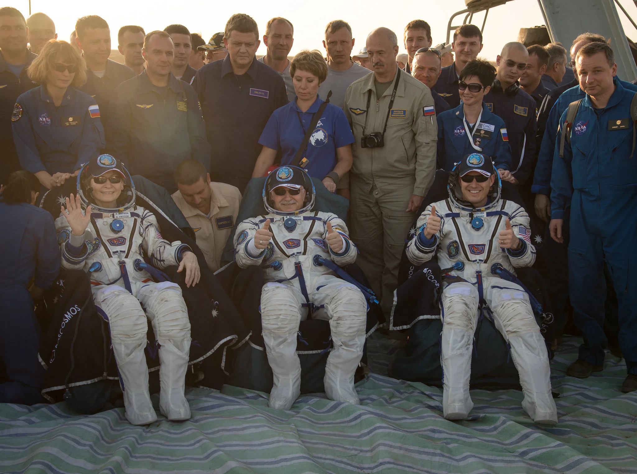 Peggy Whitson, left, Fyodor Yurchikhin, center, and Jack Fischer sit in chairs after being removed from their Soyuz MS-04 spacecraft. Credit: NASA/Bill Ingalls