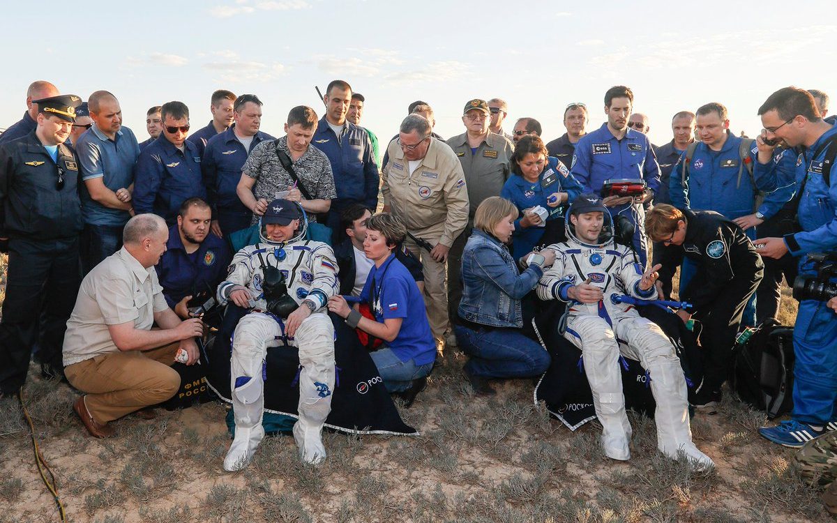 After being extracted from Soyuz MS-03, Oleg Novitskiy, left, and Thomas Pesquet were taken to couches for initial health checks and water. Credit: Roscosmos