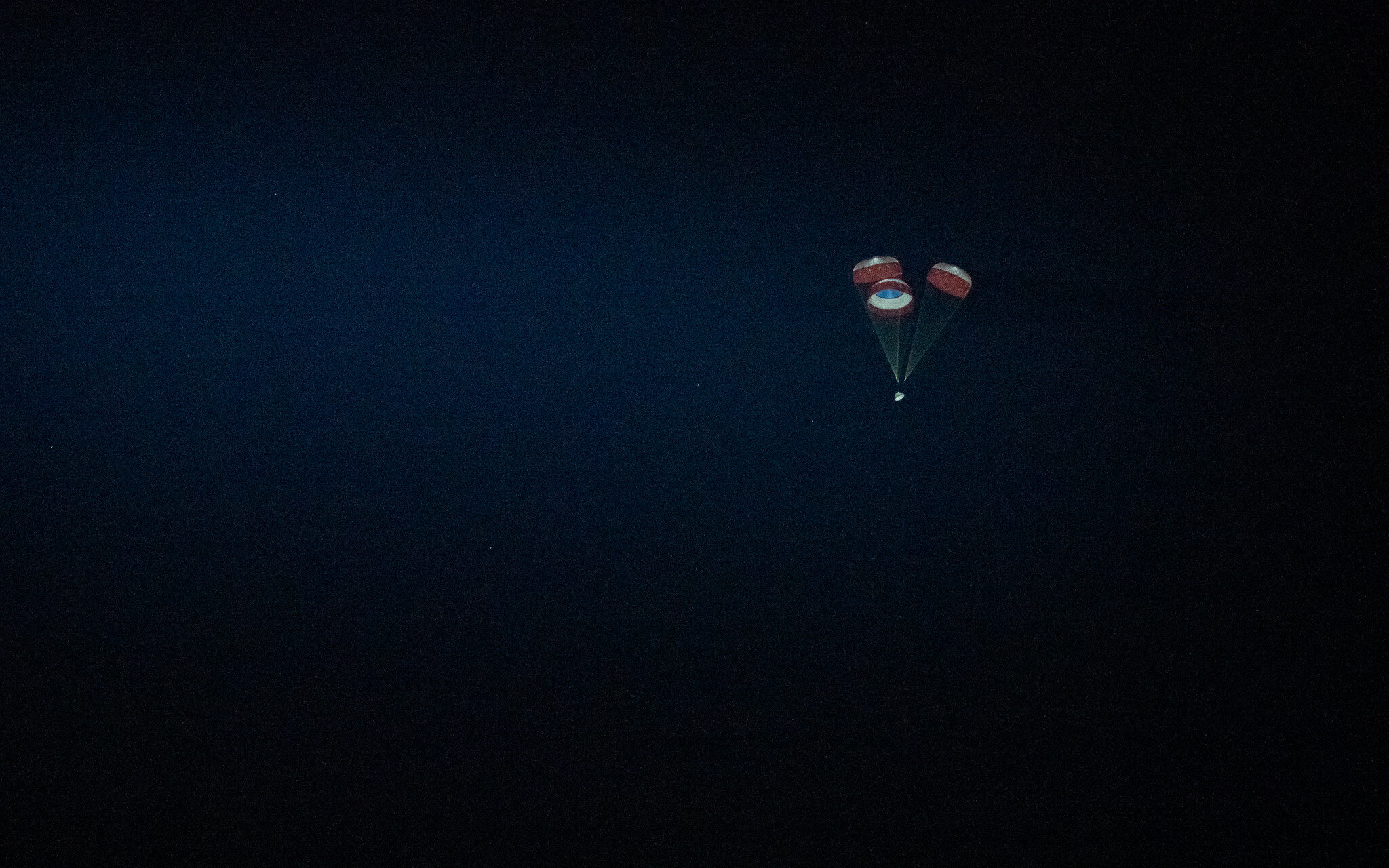  Starliner descends under three main parachutes. Credit: NASA 