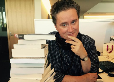 Richard Fidler, author and presenter of Conversations at his desk at the ABC.