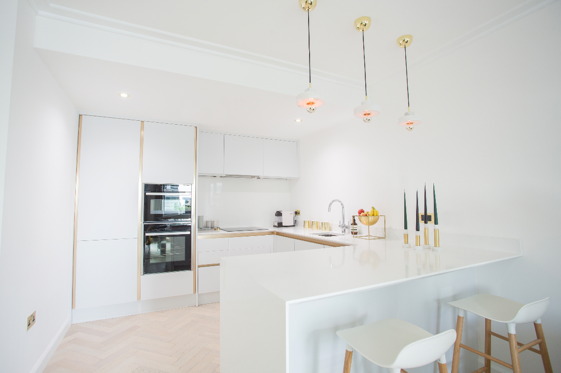 Our Discovery Docks project used a classic Peninsula breakfast bar island to separate the living space from the kitchen area.
