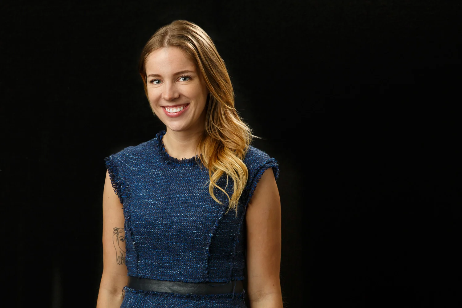 professional headshot of a white woman on a black backdrop