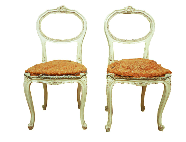 A pair of Louis XV style balloon back chairs. These chairs features a balloon back with a carving to the top center that connects to the rounded seat with nailhead trim. The seat rises above cabriole legs terminating on scroll feet. They have jute weaving to the underside.