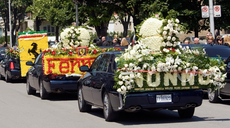  Cars covered in flowers for the procession after funeral services for  Agostino Contrera  