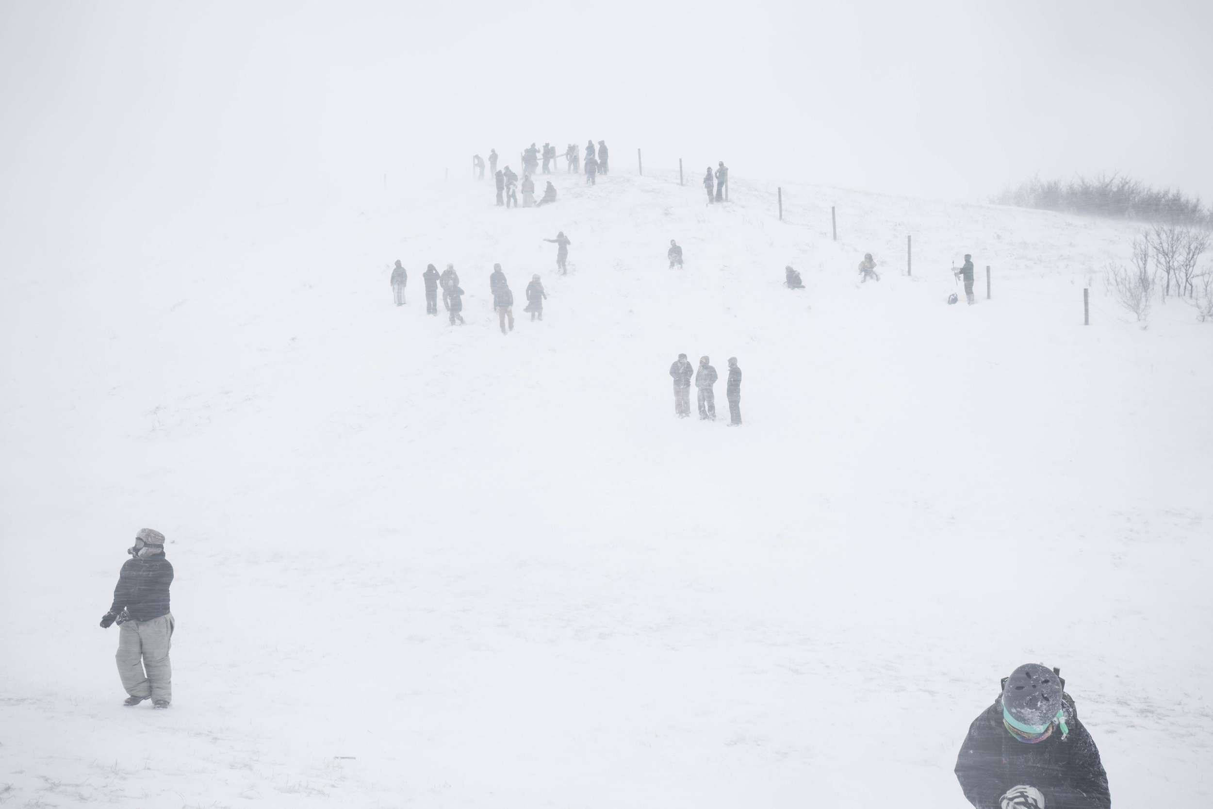 Water Protectors and veterans gather on a hill along highway 1806 on December 5, 2016 during blizzard that left hundreds if not thousands stranded in the nearby tribal casino resort.