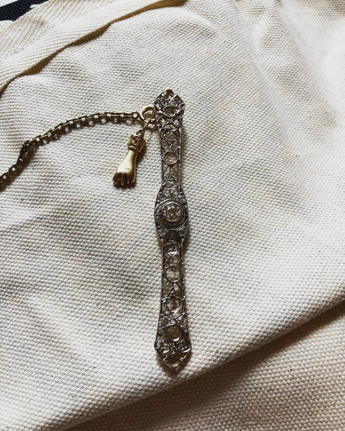 Over the years my dad started taking apart some things he thought were out of date. He would make little diamond earrings for me, my sister, my mom.  This brooch bears the scars of those gifts. But recently I found the loose center stone. He must hav