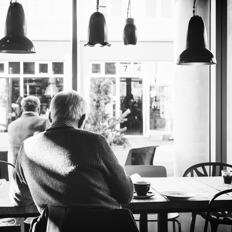 Man in a cafe having an espresso