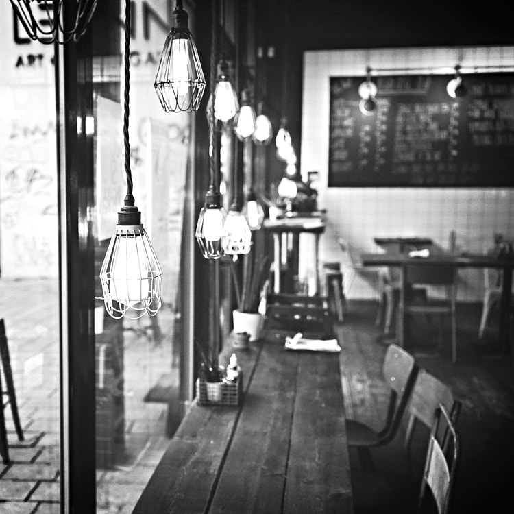 Cafe with industrial lights and a reclaimed wood counter