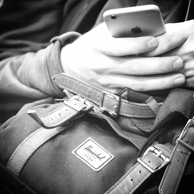 man on iphone - commuting to work