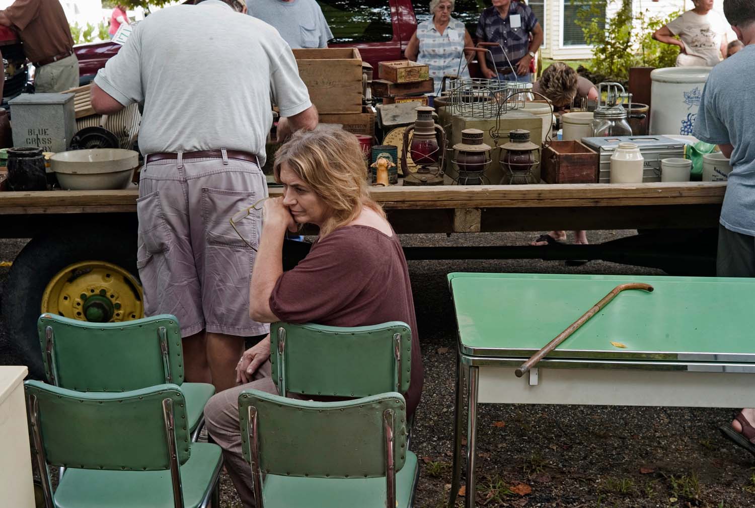  Unidentified woman sitting outside in a vintage green plastic kitchen chair at an auction. Warsaw, IL. August, 2009 