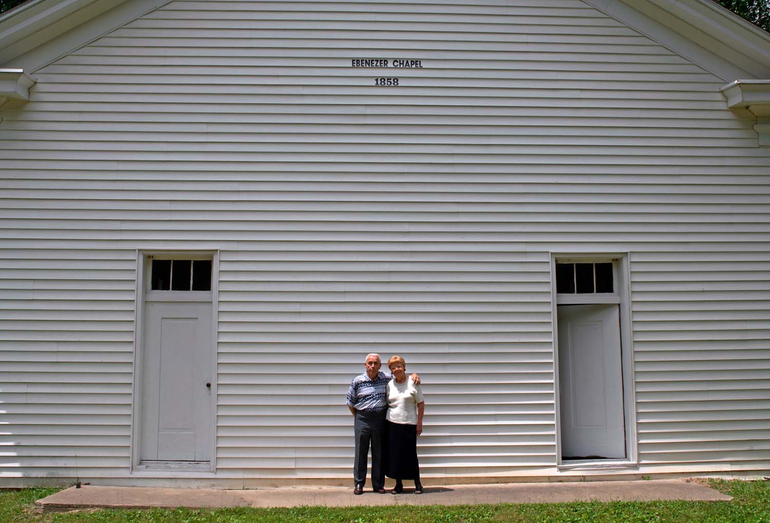  Mr. and Mrs Willard standing in front of the Ebenezer Chapel. Big Neck, IL. July, 2005 